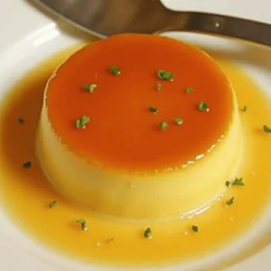 Flan with perfect caramel topping on a dessert plate.