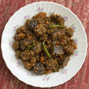 Delicious Konkani-style Brinjal Bharata served in a traditional bowl with a side of rice.