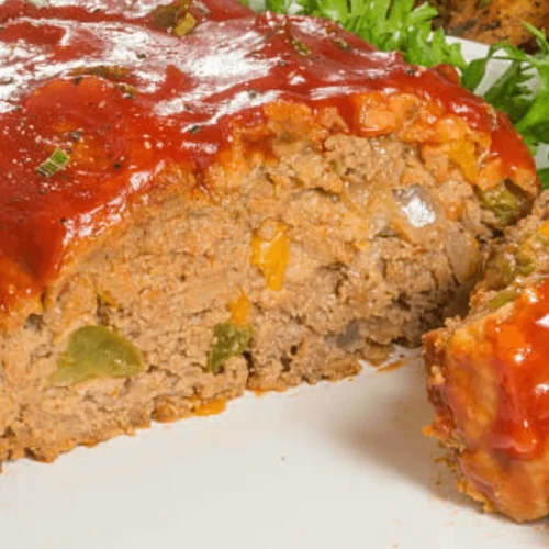 Cajun Meatloaf Pioneer Woman plated with mashed potatoes, vegetables, and gravy