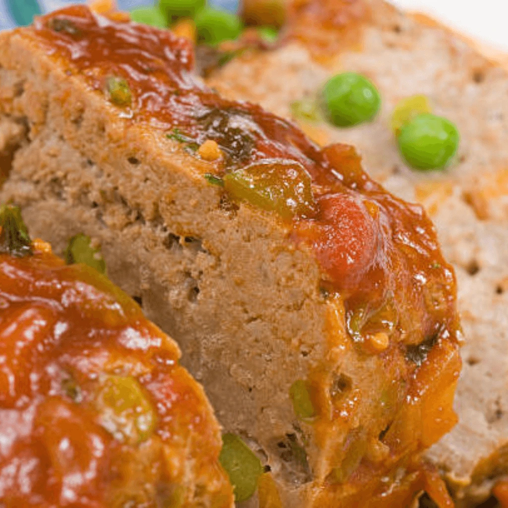 Cajun Meatloaf Pioneer Woman served with a side of mashed potatoes and vegetables