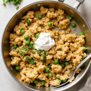 A colorful skillet filled with ground chicken, vegetables, and spices, showcasing a healthy one-pan meal.