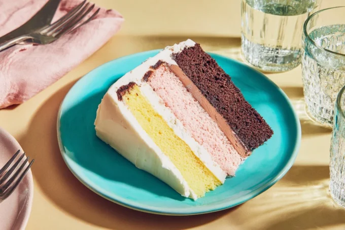 Three-layer Neapolitan cake with strawberry, chocolate, and vanilla layers