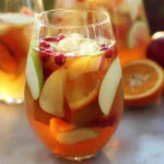 Delicious Apple Cider Sangria in a glass with fresh fruit slices