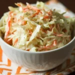 Bowl of best sweet coleslaw recipe with fresh vegetables and dressing