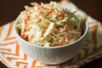 Bowl of best sweet coleslaw recipe with fresh vegetables and dressing