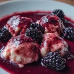 Delicious Blackberry Dumplings served with fresh berries and cream