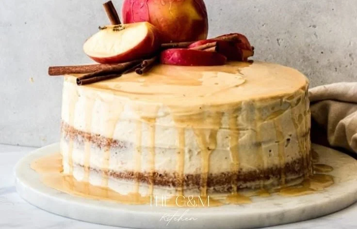 Delicious Bourbon Apple Cider Cake topped with caramel drizzle and apple slices.