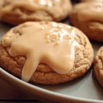 Brown sugar cookies drizzled with maple glaze on a wooden table
