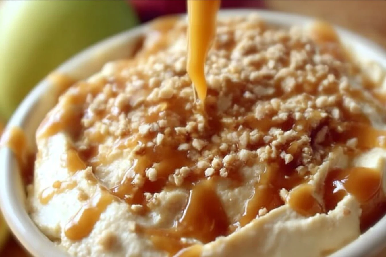 Delicious Caramel Apple Cheesecake Dip served in a bowl with apple slices