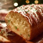 Loaf of freshly baked Christmas bread decorated with festive toppings.