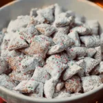 A festive bowl of Christmas Puppy Chow with colorful treats and holiday decorations.