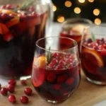 Glass of vibrant Christmas Sangria with festive fruits and spices
