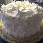 Delicious coconut cake with creamy frosting and coconut flakes on top