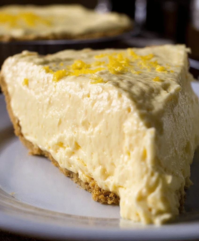 Cream Cheese Lemonade Pie topped with fresh lemon slices and whipped cream