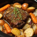 Delicious Crock Pot Roast with vegetables and herbs in a slow cooker
