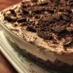 Delicious dirt cake dessert with chocolate, cookies, and whipped cream