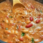 Bowl of drunken beans with colorful spices and herbs