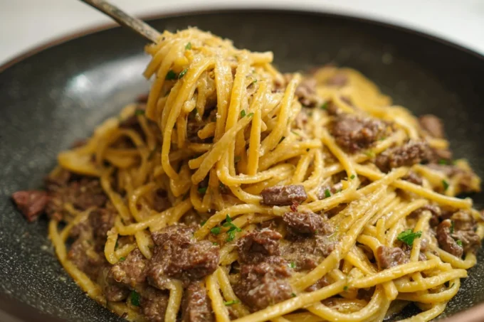 Garlic Butter Beef Pasta dish garnished with herbs and seasoning