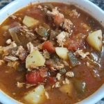 Delicious green chile chicken enchilada casserole topped with cheese and cilantro