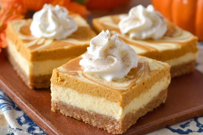 Delicious pumpkin cheesecake bars with a creamy topping and a spiced crust.