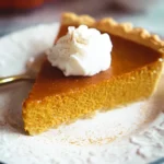 Delicious homemade pumpkin pie with whipped cream topping