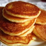 Plate of Southern Cornmeal Johnnycakes served with syrup and butter