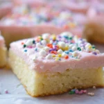 Deliciously soft sugar cookie bars topped with colorful sprinkles.