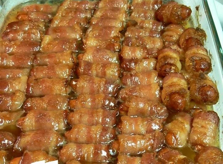 Bacon Wrapped Smokies topped with brown sugar and butter, served as a tasty appetizer.