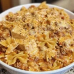 Bowtie pasta topped with creamy Velveeta beef sauce in a cozy serving dish.