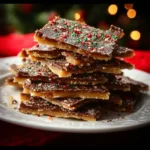 Delicious homemade Christmas Crack with chocolate and toffee layers on a festive plate