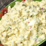 Bowl of Classic Southern Potato Salad with creamy dressing and herbs