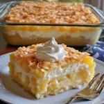 Delicious Coconut Custard Pie slice on a plate with coconut flakes