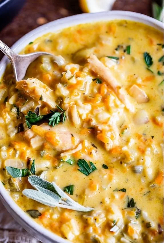 Creamy Turkey Wild Rice Soup in a bowl with herbs and spices