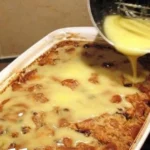 Grandma's old-fashioned bread pudding topped with creamy vanilla sauce
