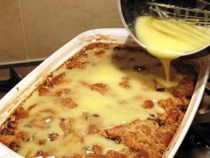 Grandma's old-fashioned bread pudding topped with creamy vanilla sauce