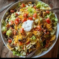 Loaded taco salad with fresh ingredients and toppings for a delicious meal.
