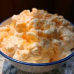 Delicious Orange Fluff Salad served on a plate, perfect for summer gatherings.