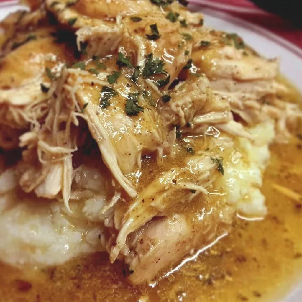 Delicious slow cooker chicken and gravy served with mashed potatoes