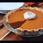 Delicious homemade Sweet Potato Pie served on a rustic table.