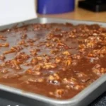 Delicious Texas Turtle Sheet Cake topped with chocolate and caramel drizzles.