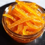 Homemade candied orange peel in syrup for baking and snacking