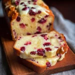 Delicious slice of Cranberry Cheesecake Pound Cake with cranberries and cream cheese