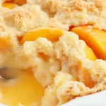 Homemade easy peach cobbler served in a rustic dish with a golden crust.