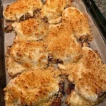 Baked chicken with Parmesan and mayonnaise, golden and crispy on a plate