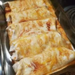 Plate of flavorful Chicken Enchiladas with sauce and cheese