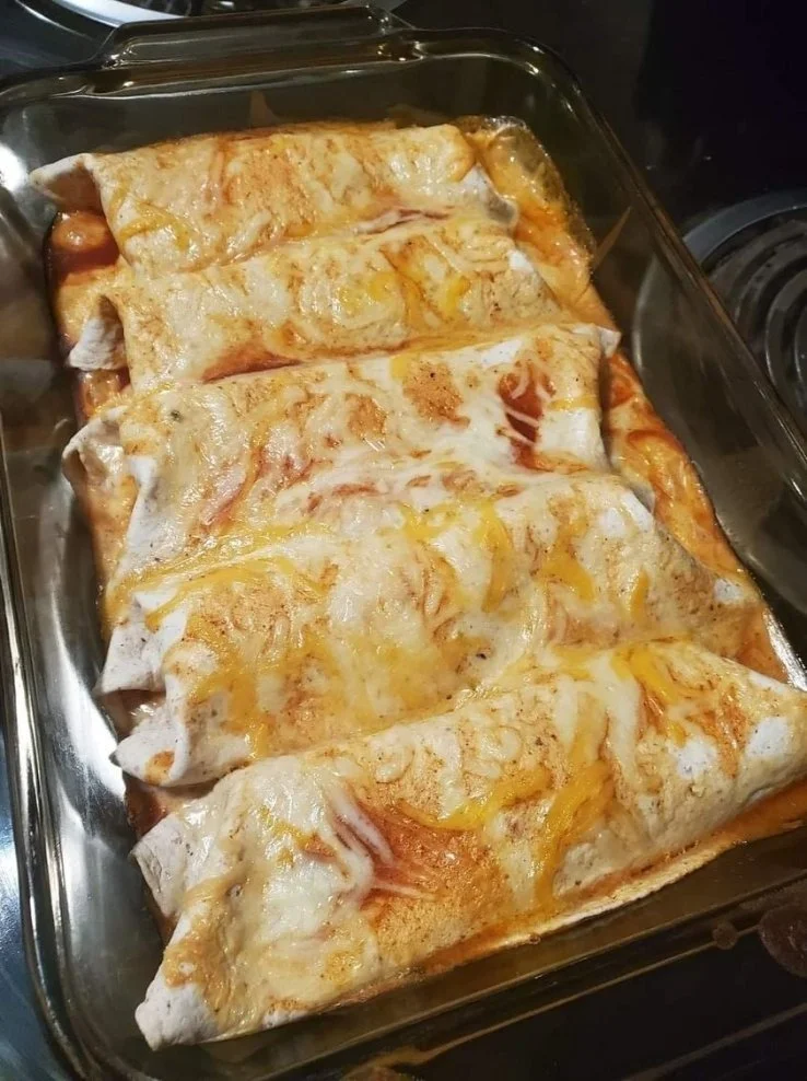 Plate of flavorful Chicken Enchiladas with sauce and cheese