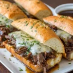 Delicious Crockpot French dip sandwiches served with au jus for dipping.