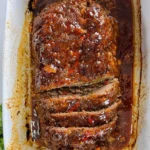 Delicious homemade meatloaf served with mashed potatoes and vegetables