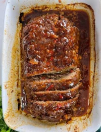 Delicious homemade meatloaf served with mashed potatoes and vegetables