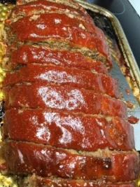 Delicious meatloaf with a savory topping, perfect for family meals.
